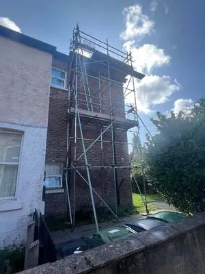 Scaffold tower up the side of a three-storey end-terrace house