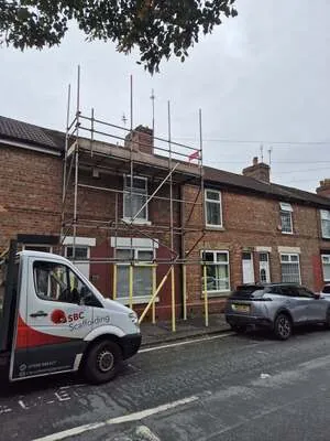 Front elevation scaffolding on a terraced street with the SBC Scaffolding van