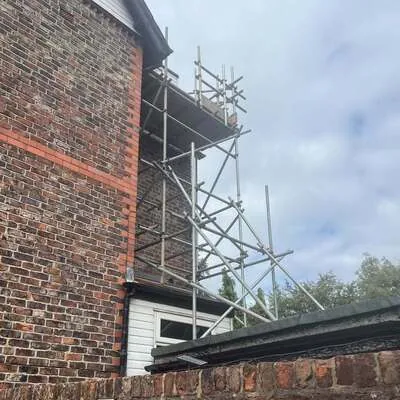 Scaffolding at the gable end of a brick house
