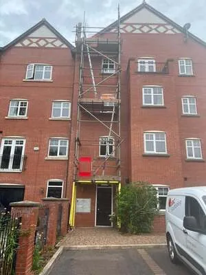 Scaffold access tower on a block of brick townhouses