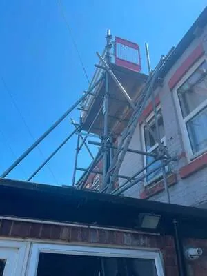Looking up at chimney scaffolding on a terraced house