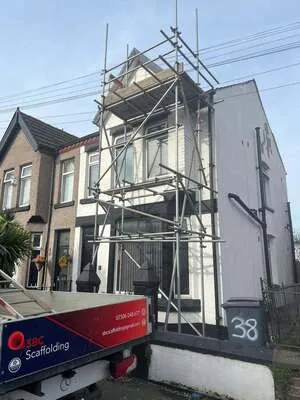 Chimney scaffold on a white-rendered end-terrace with the SBC Scaffolding van
