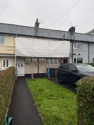 Sheeted scaffolding on the front of a terraced house