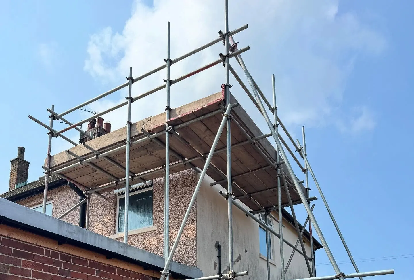 Edge protection guardrails on scaffolding around a house roof